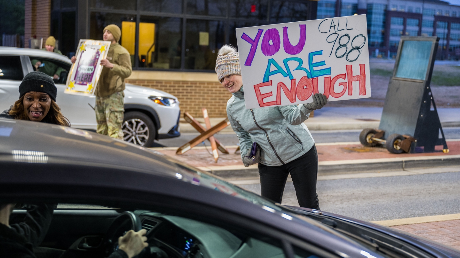 Community members participate in an event to raise awareness for suicide prevention during the holiday season