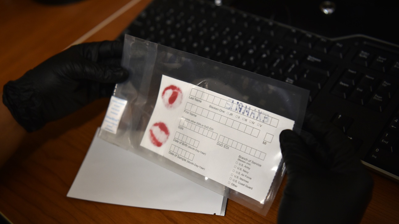 Ms. Tierra Ramos, Quality Control Processor at the Armed Forces Medical Examiner System (AFMES), holds a DNA specimen card example at Dover Air Force Base, Delaware, July 2, 2024. The Armed Forces Repository of Specimen Samples for the Identification of Remains (AFRSSIR) has been collecting DNA specimens since 1992 and now holds over 9.1 million cards. The repository receives over 250, 000 new specimen cards annually, particularly during the summer months and each card is stored for 50 years. (U.S. Air Force Photo by Staff Sgt. Alexandra Minor)