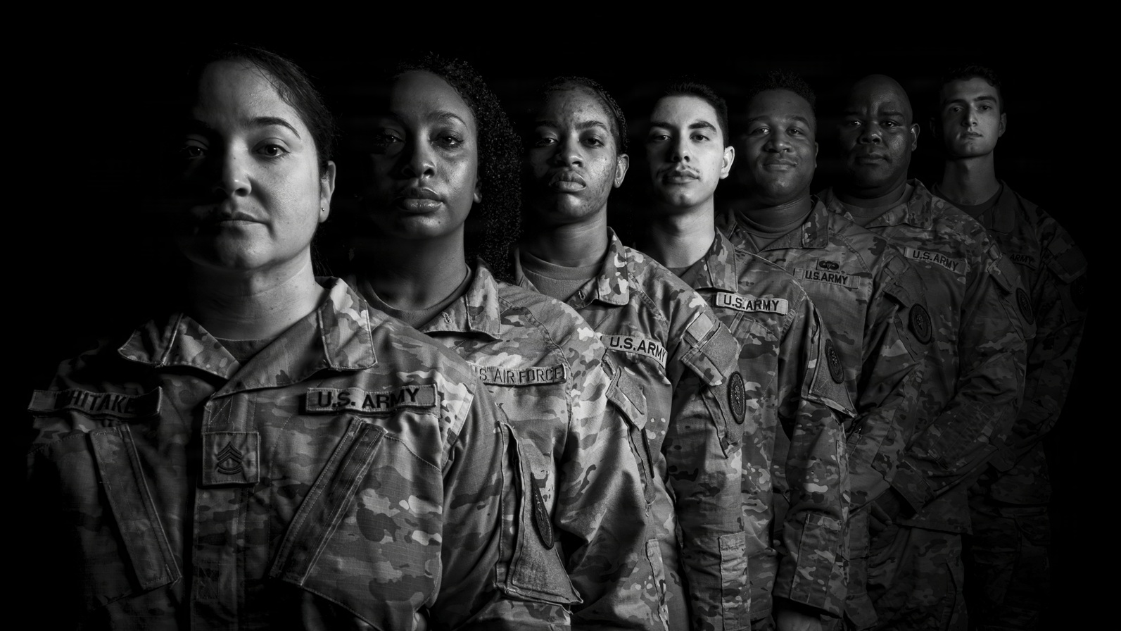 Black and white photo of 7 uniformed military personnel standing in a line