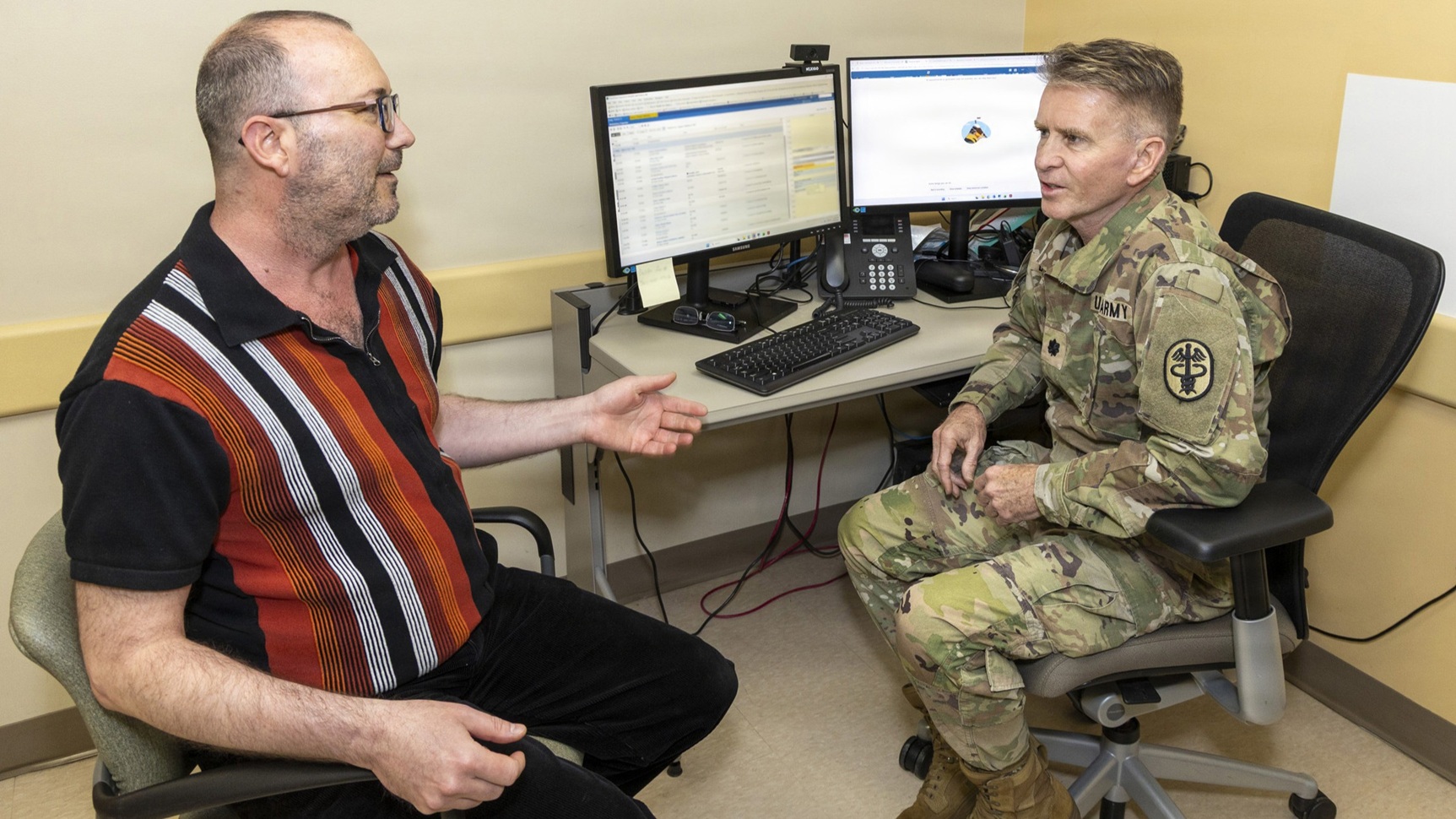 U.S. Army Lt. Col. Matthew Dugard, a primary care physician, uses ambient listening software during a patient appointment on April 20, 2026, at Walter Reed National Military Medical Center, Bethesda, Md. 
