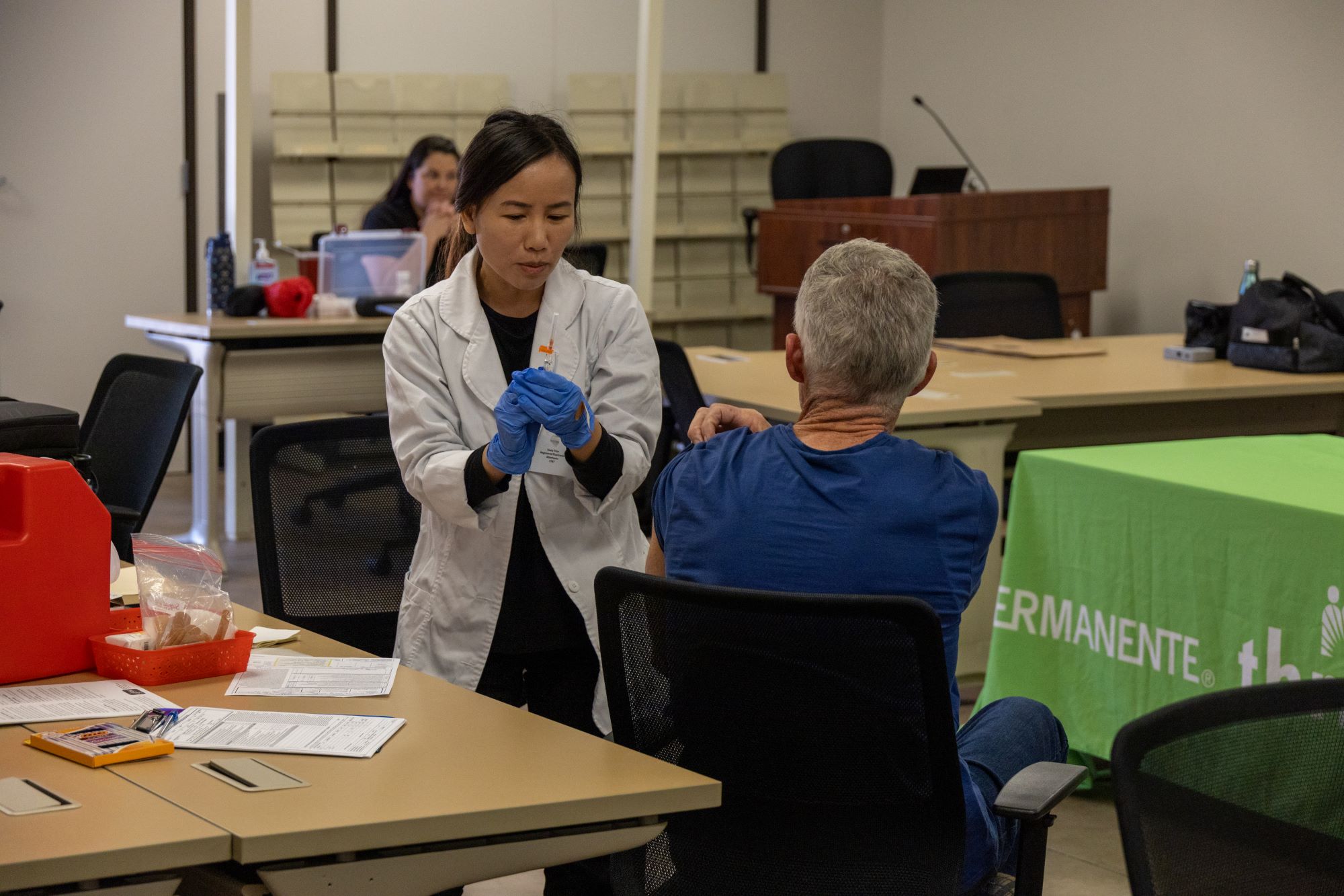 nurse giving a shot to a patient