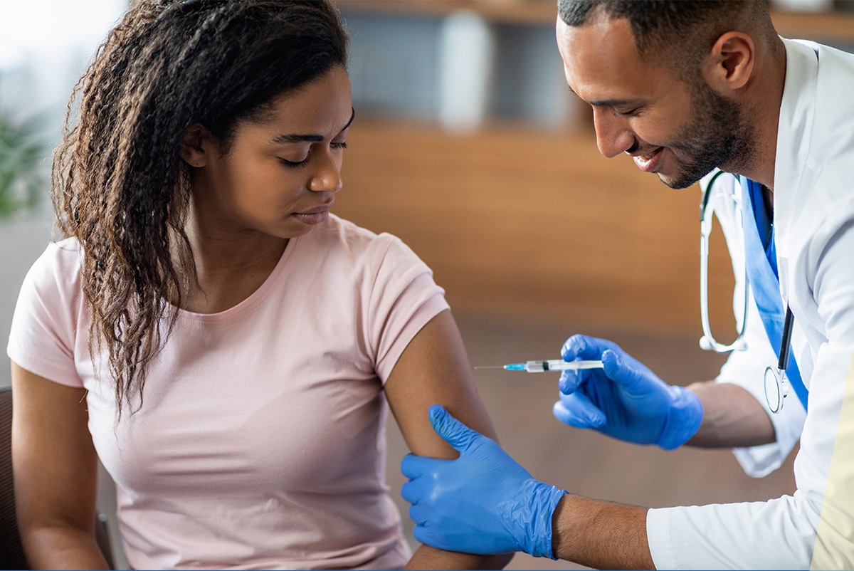 Medical personnel giving a vaccine to a woman