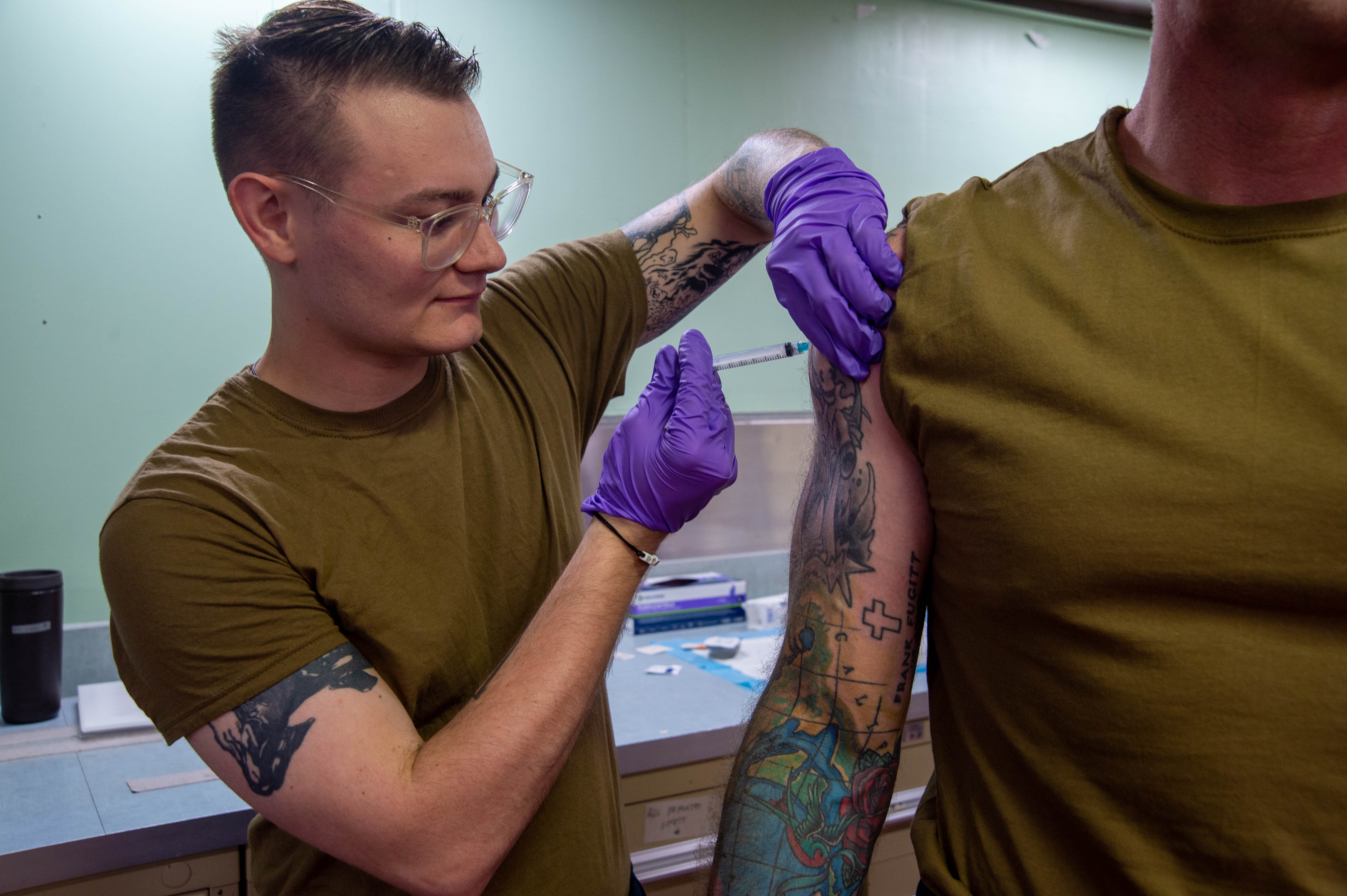 Hospital Corpsman 3rd Class Tyler Gould, from Fort Worth, Texas, gives a typhoid shot to a patient aboard the hospital ship USNS Mercy (T-AH 19).