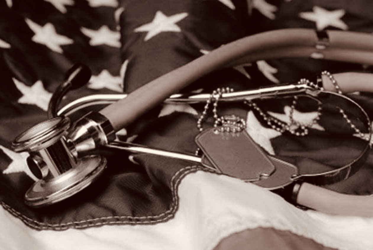 Dog tags and a stethoscope laying on an American flag