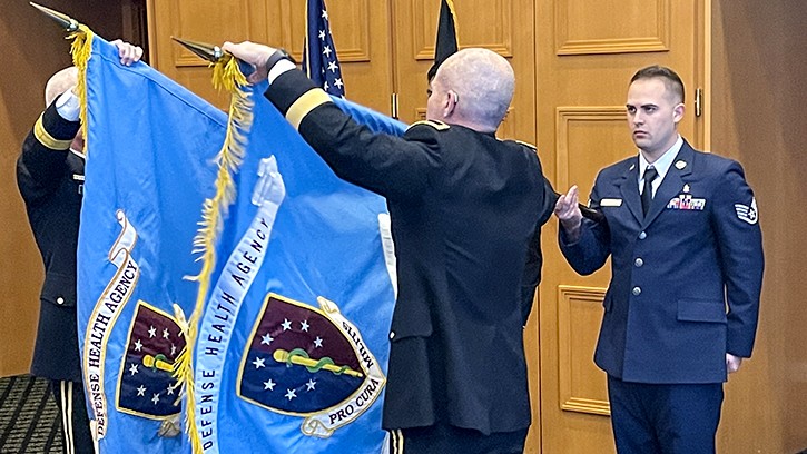 U.S. Army. Brig. Gen. Clinton K. Murray (left), the director of the DHAR-E, unfolds the DHA flag during the establishment ceremony in Garmisch, Germany