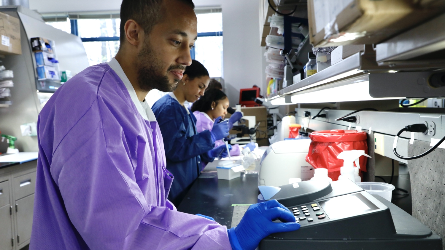 researchers in a lab run tests on samples