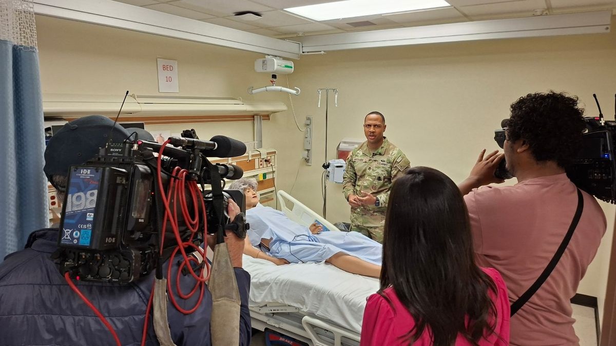 Photo By Sean Hall | JOINT BASE LEWIS-McCHORD, Wash. — U.S. Army Sgt. 1st Class Jeff Hytower, a practical nursing specialist assigned to Madigan Army Medical Center, speaks with members of the news media inside a clinical training and simulation area at Madigan Army Medical Center, Joint Base Lewis-McChord, Washington, Oct. 7, 2026. Hytower discussed his response to an Oct. 5 incident on Interstate 5 near DuPont, Washington, where he and two other Soldiers stopped to assist during a rapidly developing emergency. Hytower, who supports medical training at Madigan, said the experience reinforced the value of realistic training, sound judgment and readiness to act when seconds matter. 