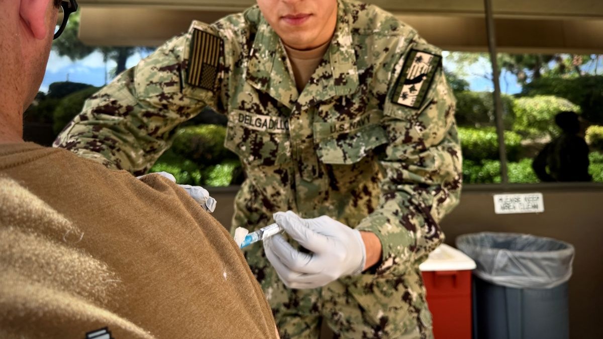 SAN DIEGO (Oct. 13, 2026) – Hospital man Apprentice Isaac Delgadillo, right, administers an influenza vaccine to a staff member at Naval Medical Center San Diego (NMCSD), Oct. 13. The evolution was part of NMCSD's annual staff influenza vaccination campaign, a command-wide effort aligned with Defense Health Agency guidelines to ensure force preservation, medical readiness and patient safety ahead of the winter season. NMCSD employs more than 5,600 active-duty military personnel, civilians and contractors in Southern California to deliver exceptional healthcare. (U.S. Navy photo by Contributed) 