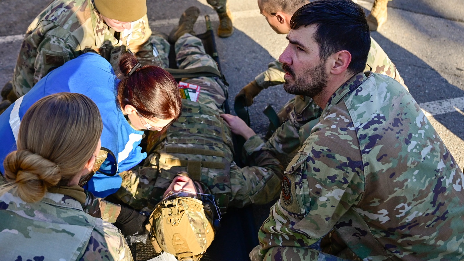 During a 19th Medical Group exercise, Airmen collaborate to process and provide treatment to volunteers staged as wounded patients at Little Rock Air Force Base, Arkansas, Jan. 23, 2025. Aimed to ensure mission readiness, The 19 MDG hosted the exercise to enhance operational capabilities and equip personnel for real-world scenarios. (U.S. Air Force photo by Airman Aidan Stein)