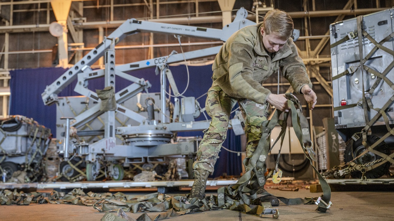 Air Force Senior Airman Tyler Ballard unfurls cargo straps while preparing equipment for shipment in support of Cope North 25 at Misawa Air Base, Japan, Jan. 24, 2025.