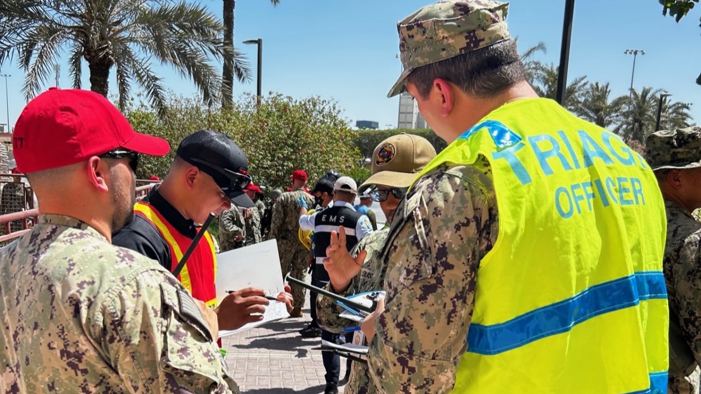 MANAMA, Bahrain (April 16, 2025) Emergency Response Team (ERT) assigned to U.S. Navy Medicine Readiness and Training Unit (NMRTU) Bahrain assess casualties at the Casualty Collection Point (CCP) during an instillation-wide mass casualty (MASCAL) exercise on board Naval Air Station (NSA) 1 Bahrain. This MASCAL exercise is the second of three Emergency Preparedness evolutions scheduled from March through May 2025 to assess capabilities and improve response safety and efficiency to potential real-world threats within the Central Command (CENTCOM) Area of Operation (AOR). Manama, Bahrain, April 16, 2025. (U.S. Navy courtesy