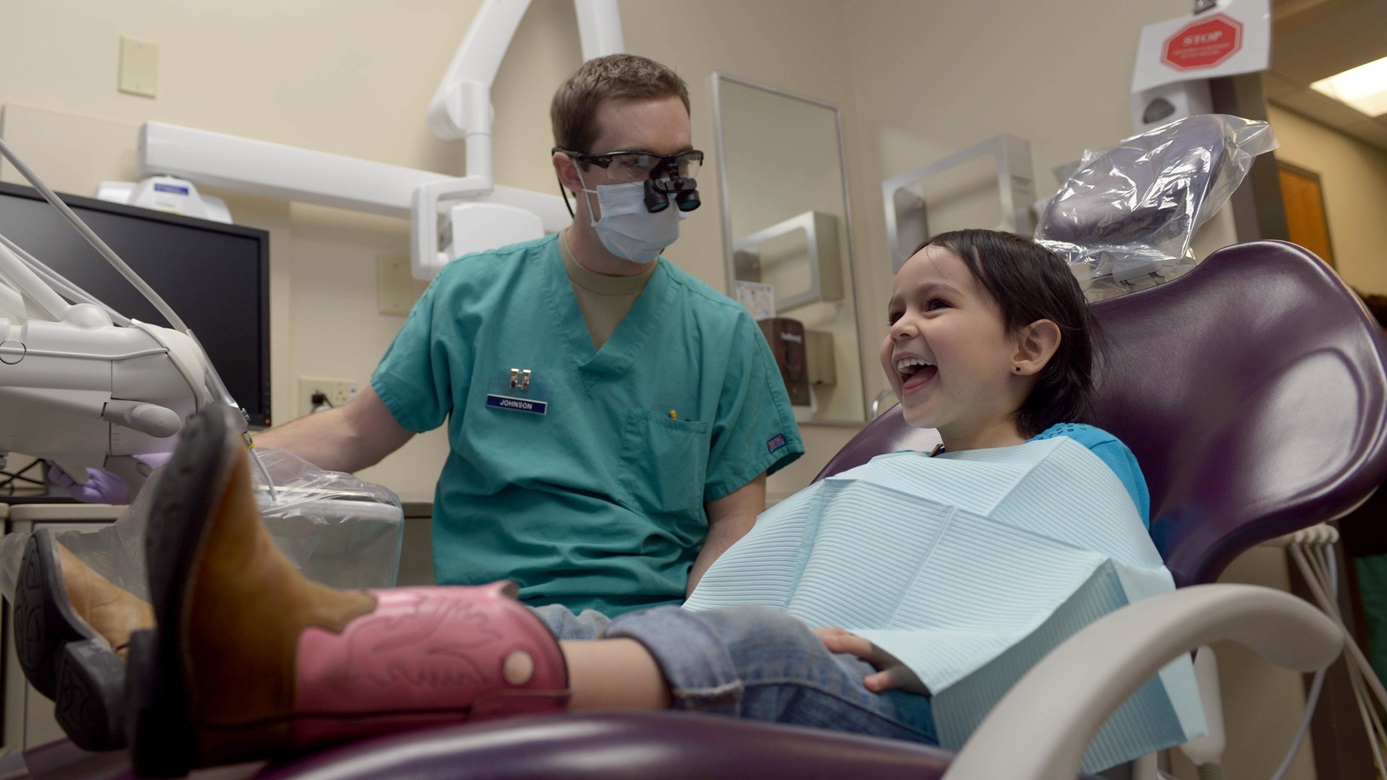 Capt. Ross Johnson, a dentist assigned to the 28th Medical Operations Squadron, prepares to do a checkup on Jaida Schlemmer, daughter of Ruben and Airman 1st Class Verenice Schlemmer, a vehicle operator assigned to the 28th Logistics Readiness Squadron, in the 28th Medical Group dental office at Ellsworth Air Force Base, S.D.