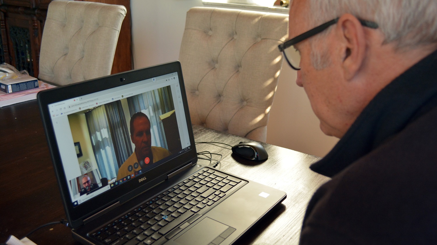 Kirk Frady, a public affairs specialist with Regional Health Command Europe, demonstrates a virtual health at-home visit with Lt. Col. (Dr.) Brent Feldt, an otolaryngologist currently assigned to Landstuhl Regional Medical Center.