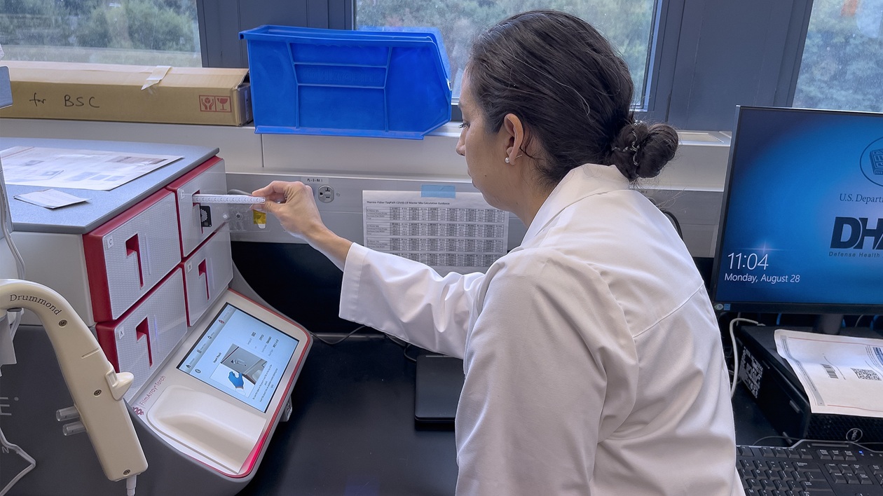  Lt. Cmdr. Sarah Jenkins, Diagnostics & Surveillance department head with Naval Medical Research Command (NMRC)’s Navy Infectious Diseases Diagnostic Laboratory, prepares to test a sample for the presence of pathogens.
