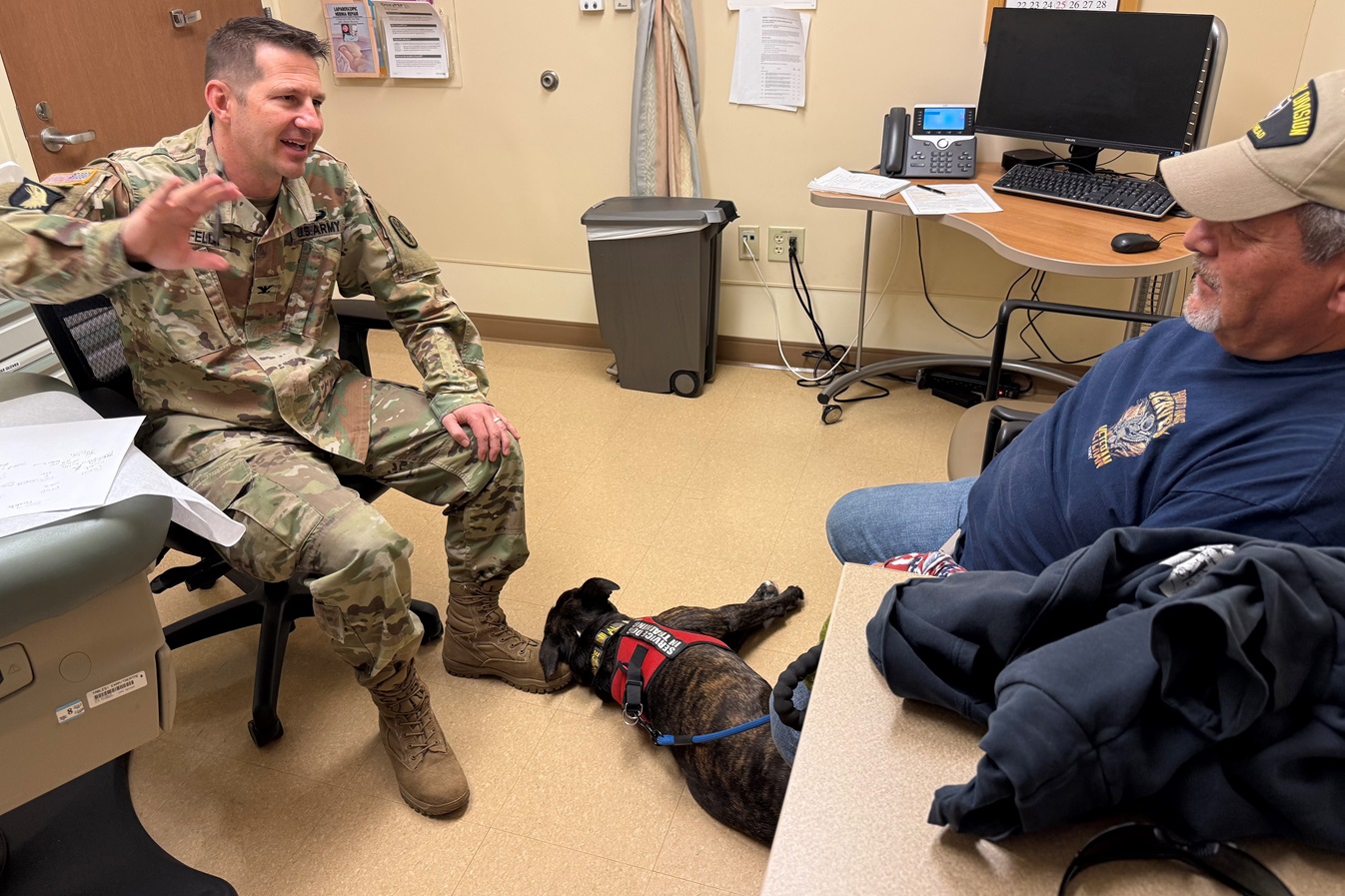 Army Col. Eric Ahnfeldt, Chief of Surgery at Evans Army Community Hospital, chats with a U.S. Army Veteran patient during an appointment at the Floyd K. Lindstrom VA Medical Clinic recently.