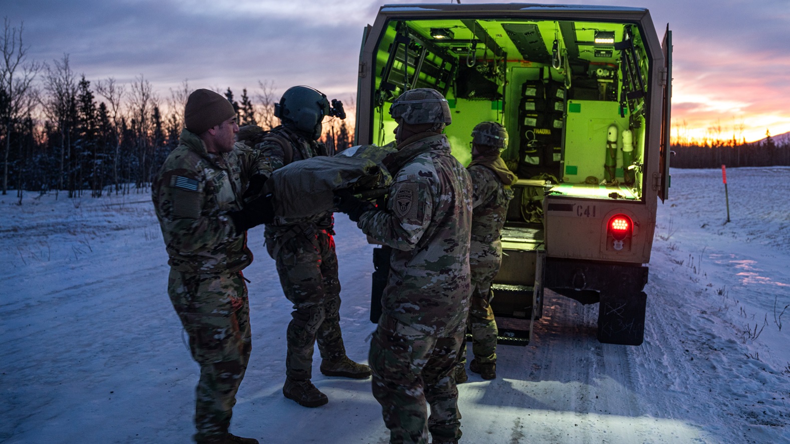 Soldiers assigned to Charlie Company, 25th Brigade Support Battalion, 1st Infantry Brigade Combat Team, 11th Airborne Division, move a simulated casualty into a Field Litter Ambulance as part of a medical evacuation rehearsal ahead of Joint Pacific Multinational Readiness Center 25-02, at the Donnelly Training Area near Fort Greely, Alaska, Jan. 18, 2025. JPMRC 25-02 is held during the coldest part of the Alaskan winter, exposing roughly 10,000 joint, multi-national service members to unforgiving conditions, building the division’s expertise in the Arctic in support of the Army, the DoD and the Nation’s Arctic and Defense Strategies. (U.S. Army photo by Sgt. Salvador Castro)