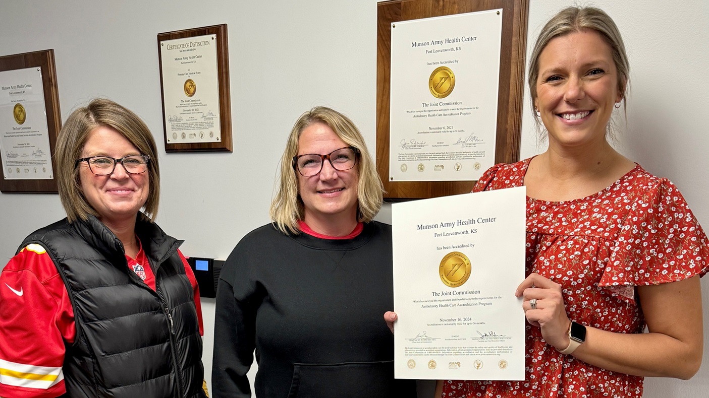 Munson Army Health Center Quality and Safety Division team members, from left, Erin Richter, Nicole Kreutzer, and Ashten Garcia, show off the health center’s newest Gold Seal of Approval, February 7. Munson Army Health Center received The Gold Seal of Approval® for Ambulatory Health Care, Patient Centered Medical Home Certification, and for Behavioral Health Care and Human Services, from The Joint Commission after an on-site inspection late last year. The Joint Commission evaluates and accredits more than 23,000 healthcare organizations and programs in the United States. The Gold Seal is a symbol of quality that reflects a health care organization's commitment to providing safe and quality patient care.