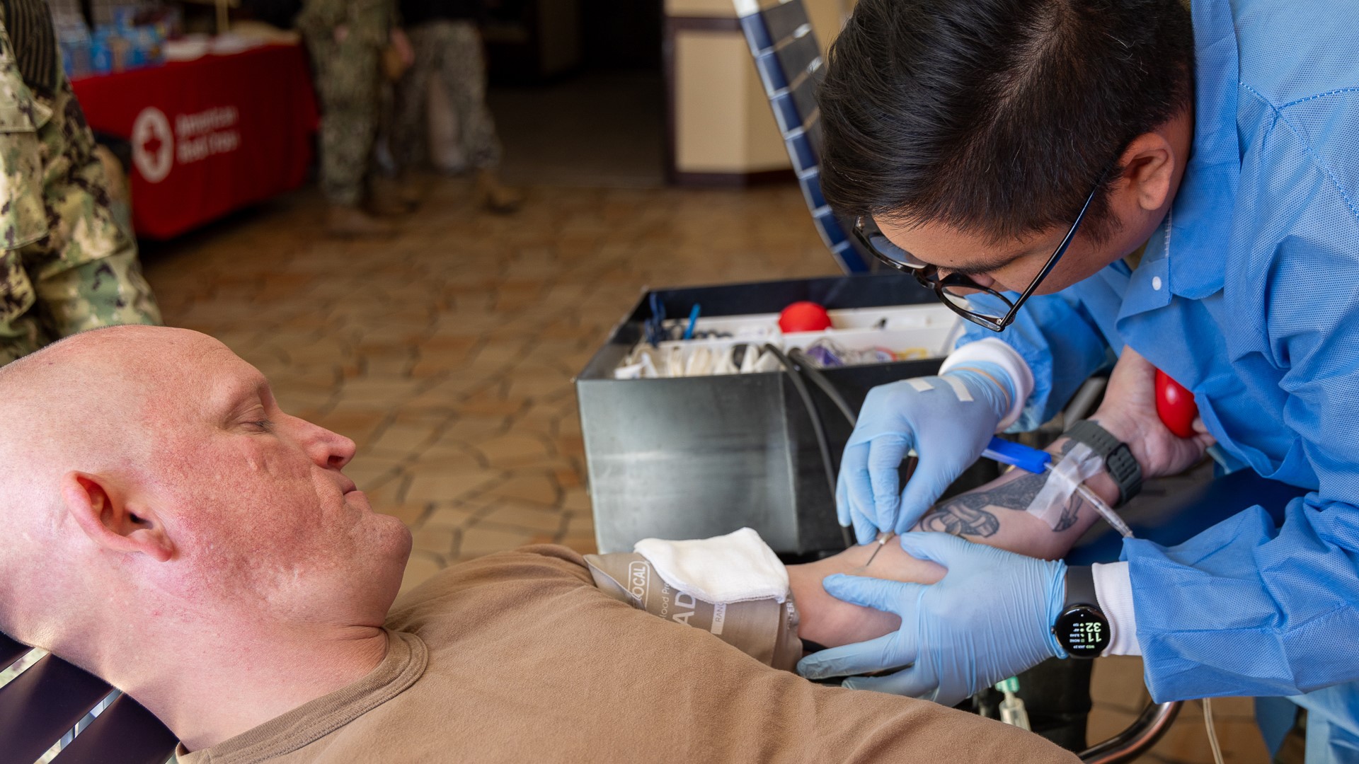 YOKOSUKA, Japan –(Jan. 29, 2025) United States Navy Medicine Readiness and Training Command (USNMRTC) Yokosuka Command Master Chief Matthew Haylow donates blood during a blood drive. Personnel from Armed Services Blood Bank Center (ASBBC) Okinawa, U.S. Naval Hospital (USNH) Yokosuka and American Red Cross volunteers conduct a blood drive at Commander Fleet Activities Yokosuka’s Officers’ Club, Jan. 29 and 30. USNH Yokosuka, in partnership with the ASBBC Okinawa, successfully hosted a groundbreaking two-day blood drive, marking the first-ever mobilization of the ASBBC Okinawa team to Yokosuka. The event saw more than 200 potential donors, resulting in 110 successful whole blood donations. This initiative plays a critical role in strengthening blood sustainment efforts within the IndoPacific region at far forward military treatment facilities (MTF). Photo by Daniel Taylor. 