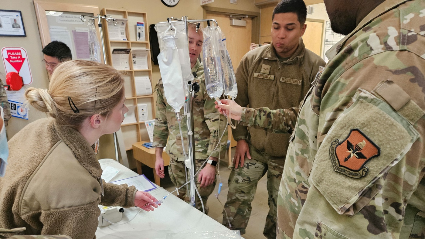 Medics from the 49th Medical Group troubleshoot a beeping IV during MEDIC-X training at Holloman Air Force Base, New Mexico, Jan. 15, 2025. Once medics determined the issue, they had to solve a puzzle to win a prize. The group has transformed its MEDIC-X training from a series of task-driven stations to interactive, adrenaline-fueled challenges -- incorporating props, prizes, and, most importantly, high-quality training.