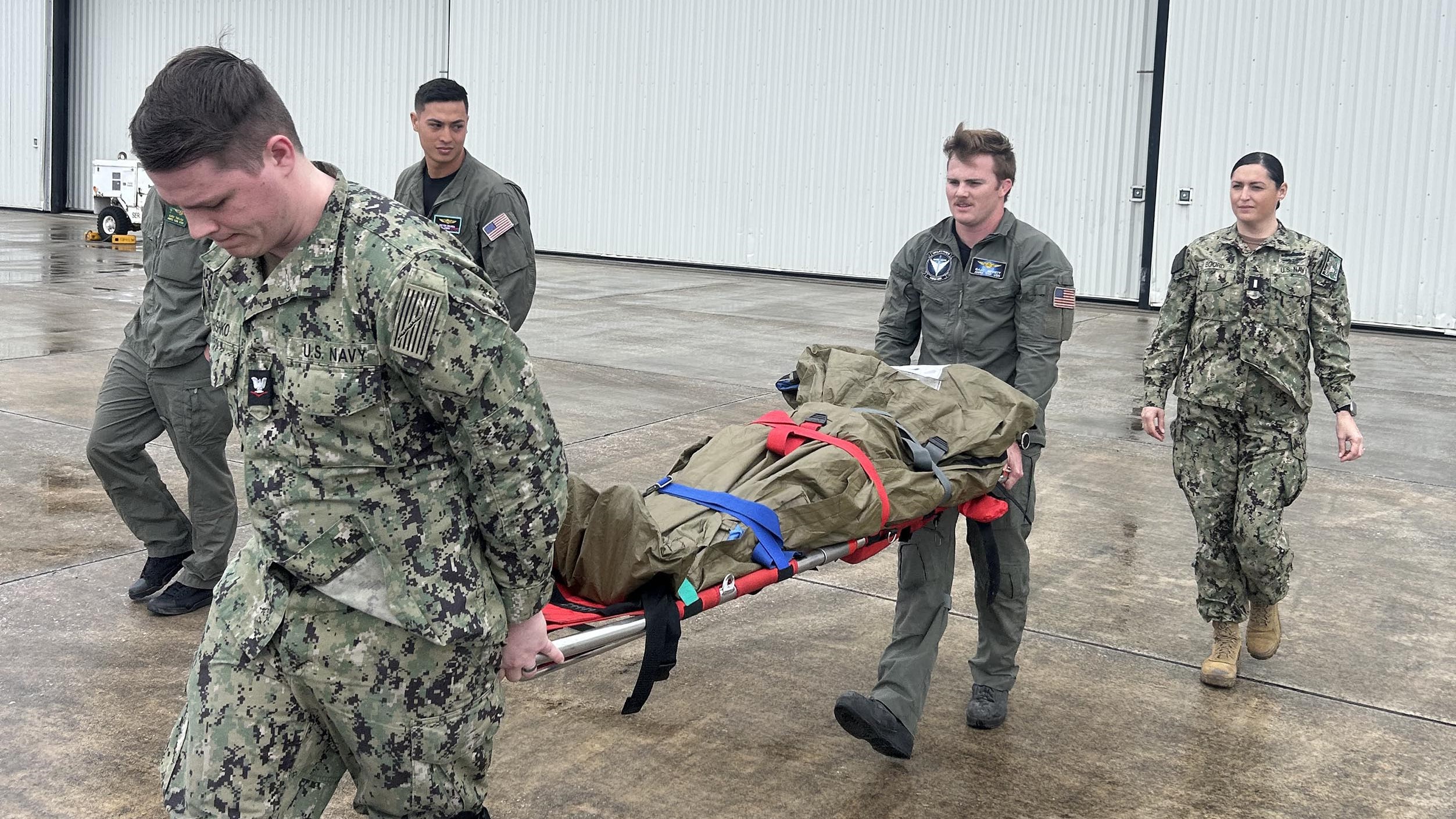 Personnel from Helicopter Maritime Strike Squadron (HSM) 50 stationed at Naval Station (NS) Mayport practice loading patients for rapid transport