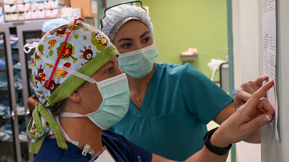 U.S Air Force 1st Lt. Nicole Davidson (left), and U.S. Air Force 1st Lt. Danika Deems, both surgical nurses with the 433rd Medical Squadron, review a list of operating room patients at the Joseph N. France General Hospital, Brumaire, St. Kitts and Nevis, March 27, 2025.