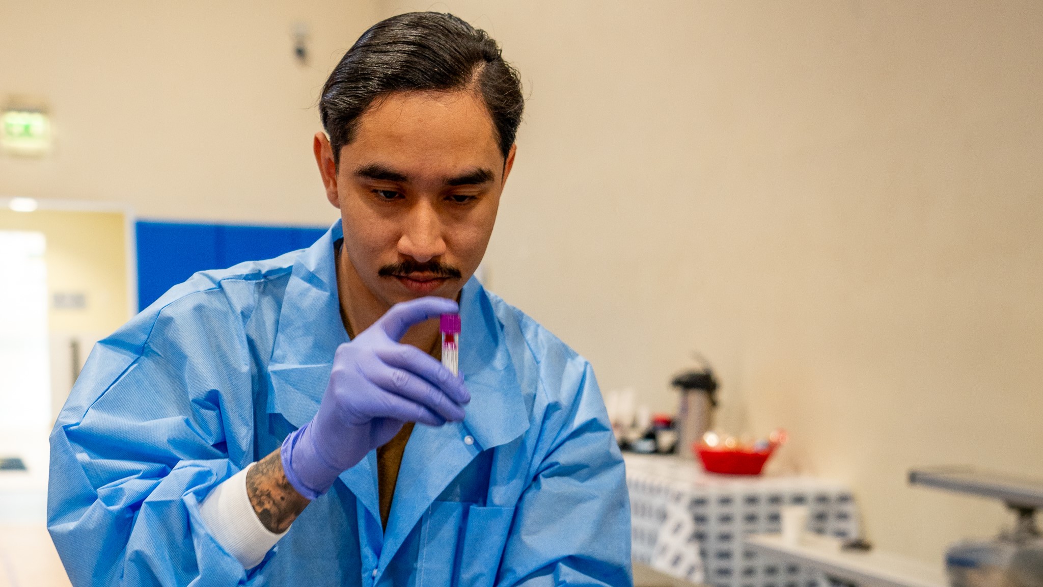 Hospital Corpsman Third Class Mark Rodriguez, assigned to United States Naval Hospital (USNH) Sigonella, prepares for a blood sample collection from a participant during the Walking Blood Bank program’s donor pre-screening event at Naval Air Station (NAS) Sigonella, April 10, 2025. (U.S. Navy photo by Hospital Corpsman 1st Class Carlos Villegasmejia).