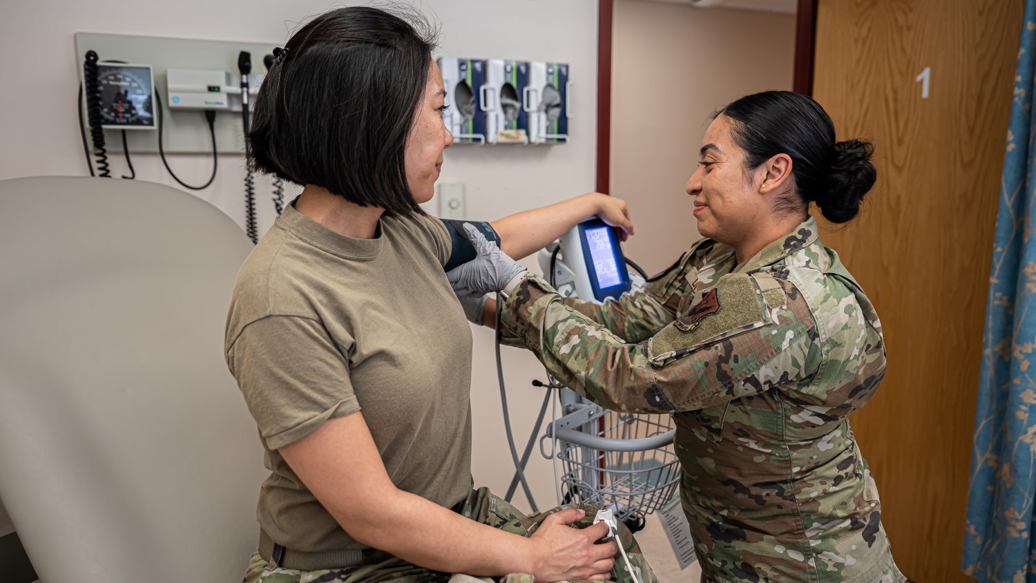 Staff Sgt. Yesica De Leon, non-commissioned officer in charge of the Warrior Operational Medicine Clinic for the 319th Operational Medical Readiness Squadron, removes a blood pressure cuff off of Capt. Holly Prouty, Aerospace Medicine Flight Commander for the 319th Operational Medical Readiness Squadron at Grand Forks Air Force Base, N.D., April 3, 2025. De Leon provides direct patient care for military members, dependent family members and veterans that report to the 319th Medical Group. (U.S. Air Force photo by Airman Nailah Pacheco)