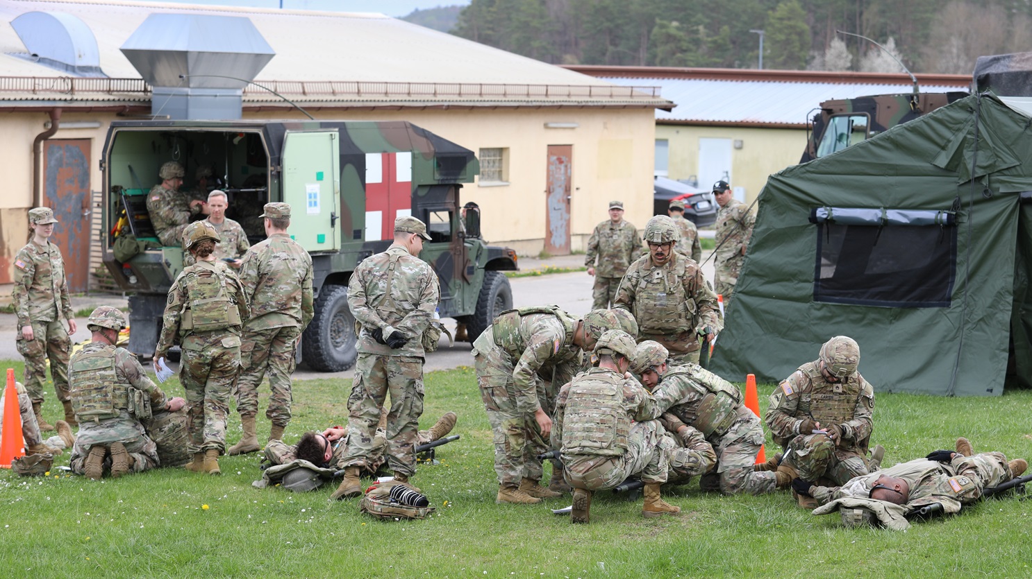 Soldiers from U.S. Army Health Clinic Hohenfels triage a simulated casualty after unloading from a Field Litter Ambulance during a mass casualty training exercise at the Joint Readiness Training Center, Camp Albertshof, Hohenfels, Germany, April 17, 2025. The exercise focused on strengthening emergency response skills and enhancing medical readiness in a realistic training environment. (DHA photo by Rachel Herrod)