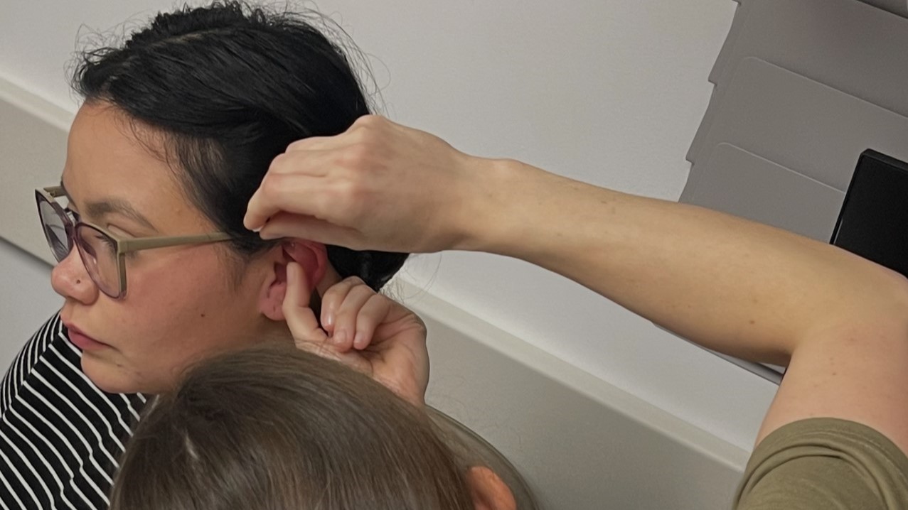 Maj. Melissa Perkins, a nurse practitioner assigned to Bassett Army Community Hospital, inserts a needle into Joann Allison's ear as a pain management tool April 25, 2025. Battlefield Acupuncture (BFA)is a specific protocol developed in the early 2000s by Air Force physician Dr. Richard Niemtzow. Unlike traditional acupuncture, which utilizes hundreds of points across the body, BFA focuses on five targeted locations in the ear to disrupt pain signals and activate the body’s natural healing mechanisms.