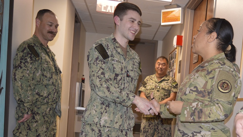 Mission readiness recognition… Chief Master Sergeant Tanya Y. Johnson, Defense Health Agency’s senior enlisted leader presents a personal challenge coin to Hospital Corpsman 2nd Class Cade Crenshaw, assigned to Naval Hospital Bremerton Mental Health Directorate as a behavioral health technician, acknowledging his contributions as a deckplate leader.  (Official Navy photo by Douglas H. Stutz, NHB/NMRTC Bremerton public affairs officer).