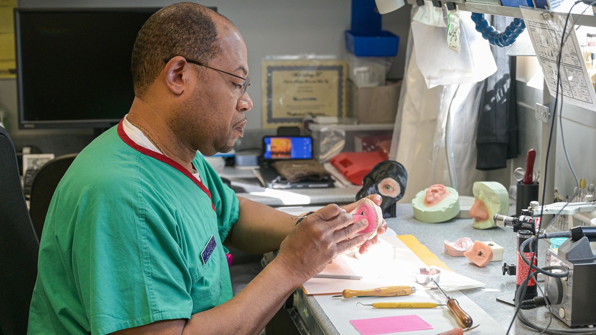 Robert Robinson, 633d Dental Squadron anaplastologist maxillofacial prosthetist, uses a dental tool to shape an orbital prosthesis, at Joint Base Langley-Eustis, Virginia, April 9, 2025. Robinson is the only board-certified anaplastologist in the Department of Defense and has been working at JBLE since 2016. (U.S. Air Force photo by Senior Airman Adisen Smith)