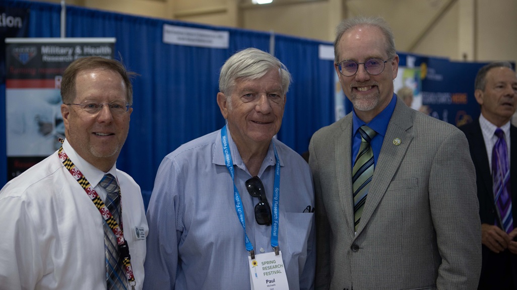 Dr. Paul Michaels, center, director of the Defense Health Agency Research and Development-Medical Research and Development Command’s Office of Medical Technology Transfer, pauses for a photo with City of Frederick Mayor Michael O’Connor, right, and the city’s Director of Economic Development Richard Griffin at the 2025 Spring Research Festival Symposium and Exhibition at Fort Detrick April 30.