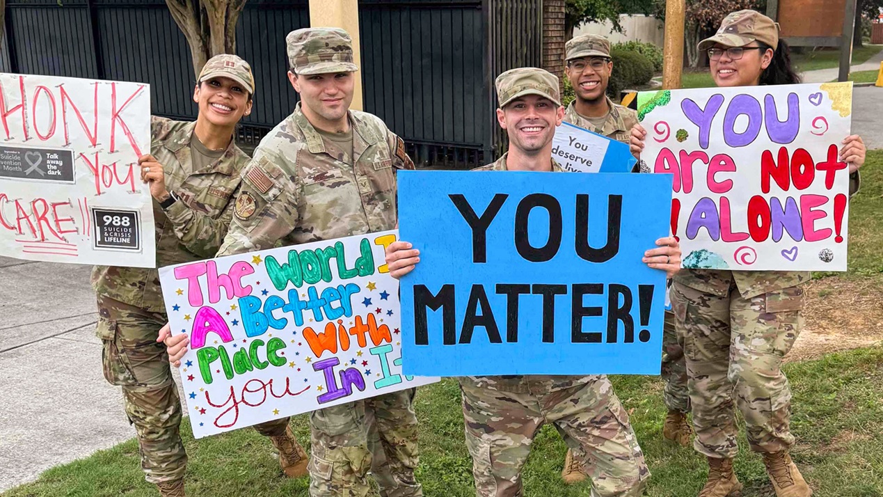 U.S. Air Force medics greet cars driving into Keesler Air Force Base with words of encouragement for Suicide Prevention Month, Biloxi, Mississippi, September 2025. (Courtesy photo from U.S. Air Force Lt. Col. Elisha Pippin)