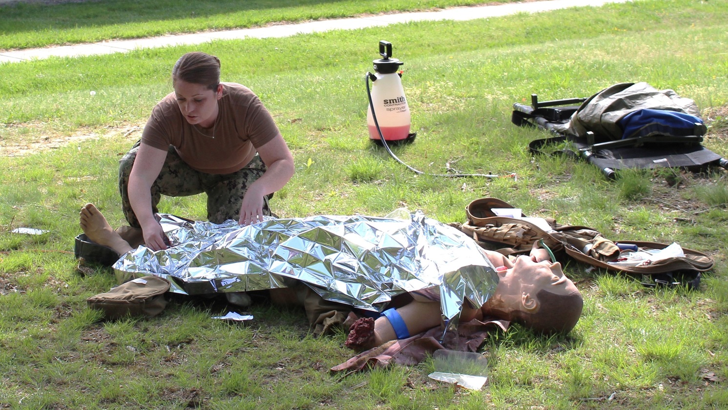 Hospital Corpsman Second Class (HM2) Brianna Connaghan assesses a mannequin for injury during a Tactical Combat Casualty Care (TCCC) Course at Navy Medicine Readiness and Training Command (NMRTC) Patuxent River.