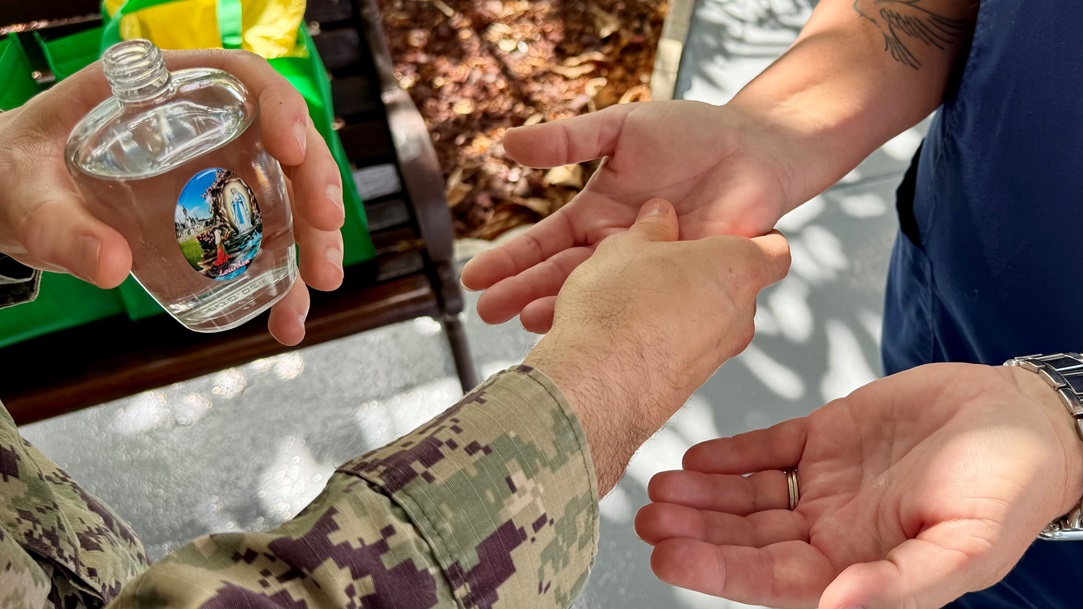 Naval Station Guantanamo Bay Staff Chaplain, Lt. Ben Pitre, blesses hands during a ceremony held at U.S. Naval Hospital Guantanamo Bay, May 13, 2025. The Blessing of the Hands is a traditional ceremony among healthcare workers that serves as a spiritual moment of reflection and renewal, recognizing that a nurse’s hands are instruments of compassion, comfort and care. (U.S. Navy photo by Emily McCamy/released)