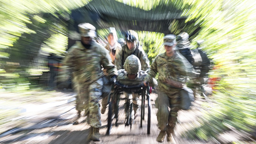 U.S. Army medics transport a role player patient toward an emergency room tent during a mass casualty exercise as part of Exercise Dynamic Employment of Forces to Europe for NATO Deterrence and Enhanced Readiness (DEFENDER) 2025, Vepriai Rocket Base, Lithuania, May 15, 2025.