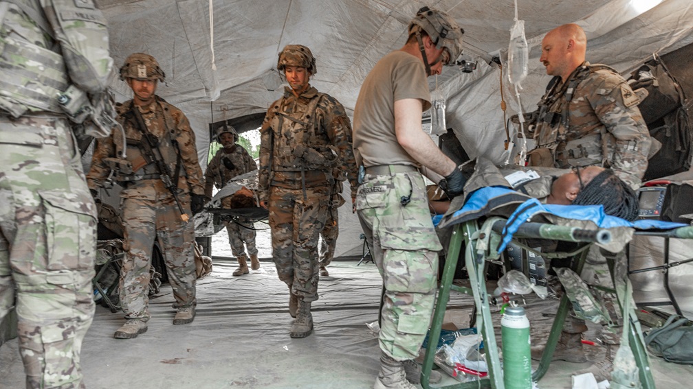 gt. Jacob Montgomery, a combat medic with the 501st Aviation Battalion, 1st Armored Division, and Capt. Aaron Chapman, an air medical physician assistant with the 501st Aviation Battalion, 1st Armored Division, perform a point-to-point blood transfusion on a simulated casualty during Exercise Combined Resolve 25-2 May 18, 2025 in Hohenfels, Germany.