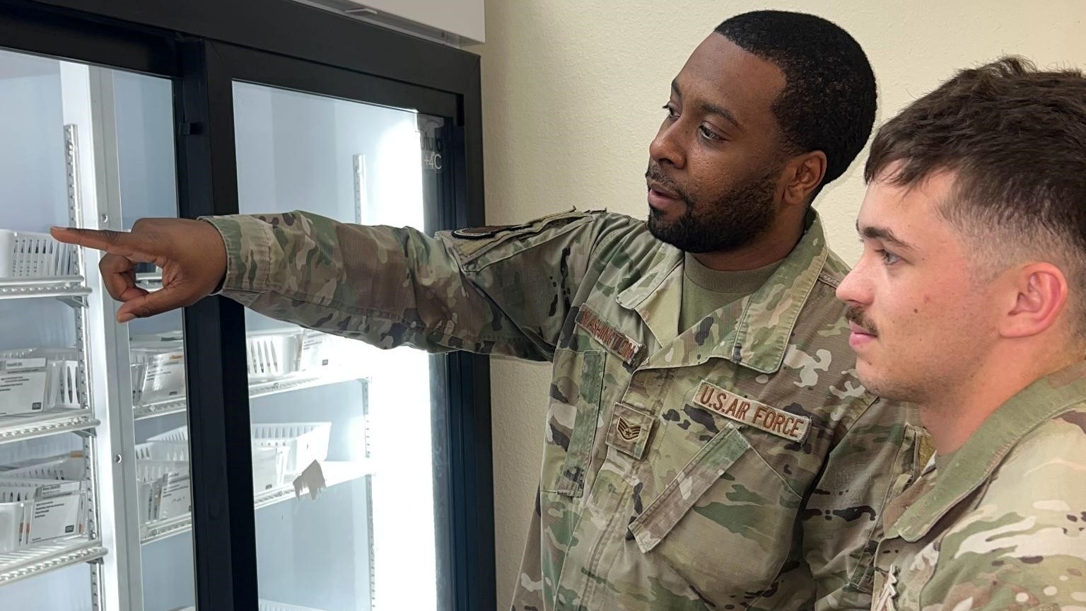 U.S. Air Force Staff Sgt. Joshua Washington, 375th Medical Group allergy and immunizations technician from Scott Air Force Base, Ill., and Airman 1st Class Easton Schlabaugh, 17th Medical Group allergy and immunization technician, from Goodfellow AFB, Texas, review immunization vials, studying which vaccines are given to different age groups and how often they need to be administered, at Goodfellow AFB. Washington assisted the Goodfellow team to enhance immunization operations.