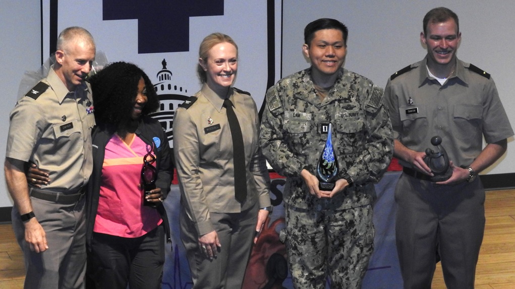 U.S. Army Col. Kenneth Dwyer (left), Commander of the Leader Training Brigade at Fort Jackson, South Carolina, thanks and recognizes members of Walter Reed's nursing team during a recent nurse appreciation and awards program at the medical center.