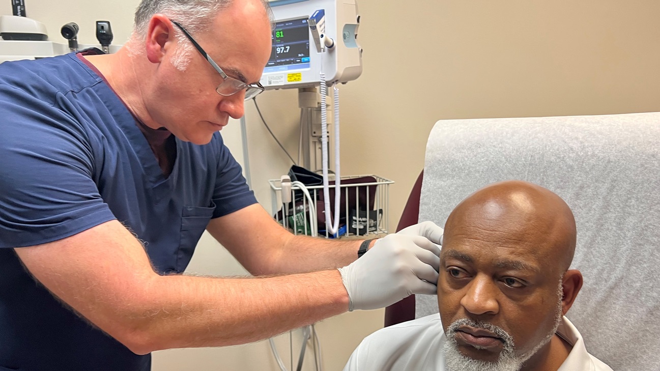 Willie Shelton, physician assistant at Bayne-Jones Army Community Hospital administers battlefield acupuncture to retired 1st Sgt. Thomas Washington, July 1, at the Joint Readiness Training Center and Fort Polk, Louisiana. Washington has been receiving the treatment for chronic back pain for the past two years.