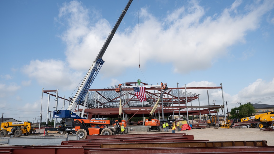 Contractors raise the final steel beam into place at the future Dunn Dental Clinic during a topping-out ceremony at Joint Base San Antonio-Lackland, Texas, July 16, 2025.