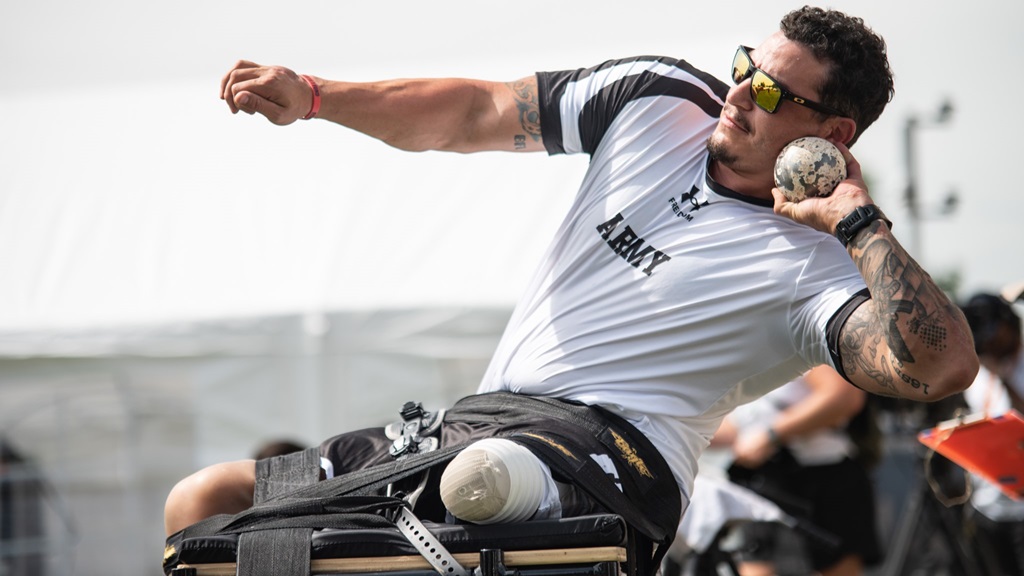 Man in wheelchair getting ready to throw a ball