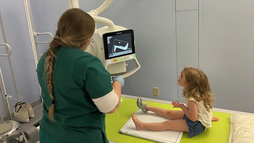 X-ray Technician student Olivia Tucker at Bassett Army Community Hospital located in Fort Wainwright, Alaska, takes extra time to explain each step of 3-year-old Hazel’s cast removal to ease her fears and ensure that she feels safe before beginning medical care.