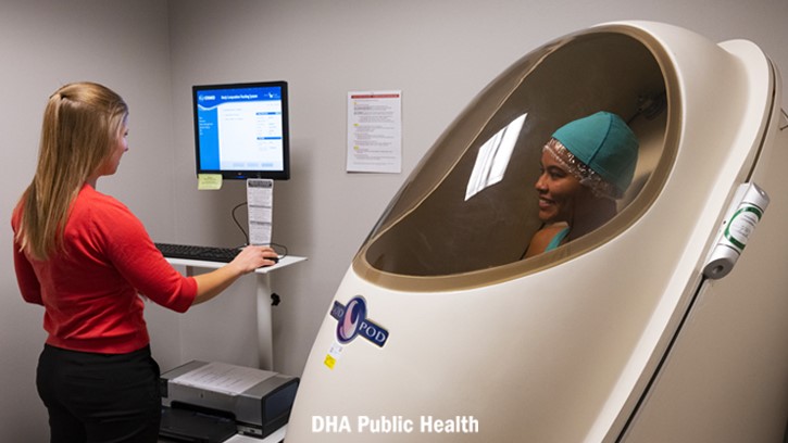 Samantha Nielson, Peterson Space Force Base health promotions registered dietician, runs the Body Composition Machine for U.S. Air Force Airman 1st Class Aliviah Williams, Space Base Delta 1 public affairs specialist
