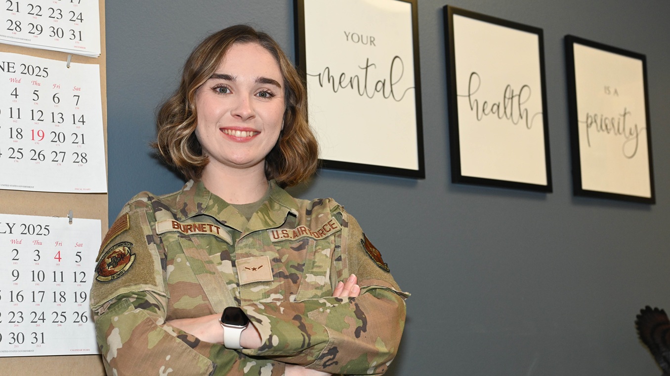 U.S. Air Force Airman Laura Burnett, 28th Operational Medical Readiness Squadron mental health technician, poses in her work center, representing Raider of the Week at Ellsworth Air Force Base, S.D., June 12, 2025.