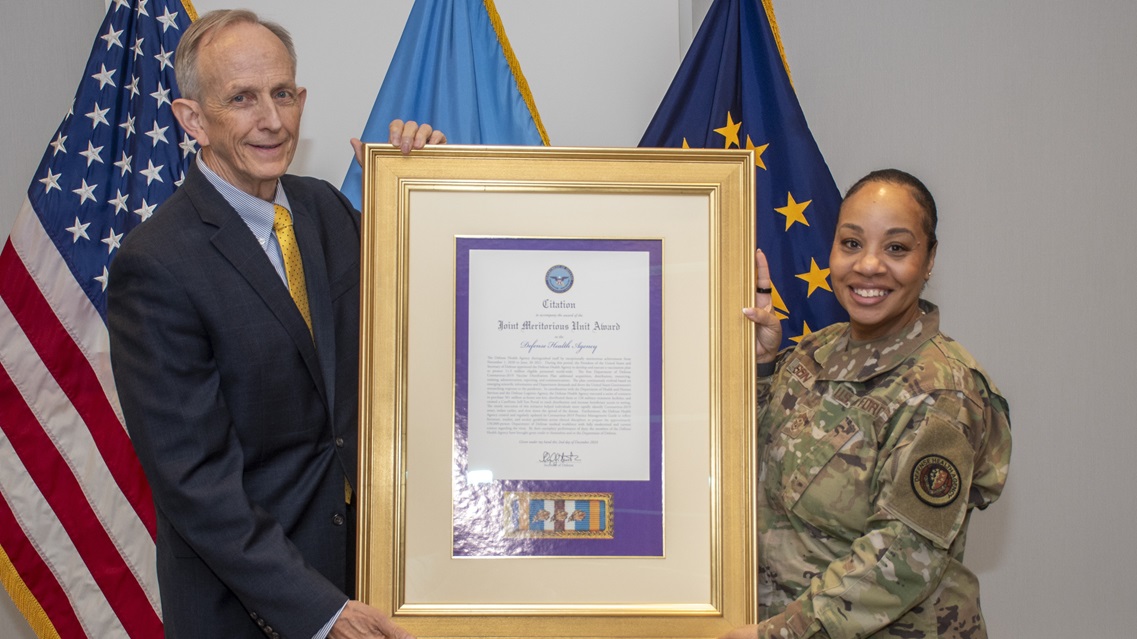 Acting Defense Health Agency Director Dr. David Smith and Senior Enlisted Leader U.S. Air Force Chief Master Sgt. Tanya Johnson accepted the Joint Meritorious Unit Award presented by the Department of Defense to the Defense Health Agency during an award ceremony at Defense Health Headquarters on July 17, 2025. 