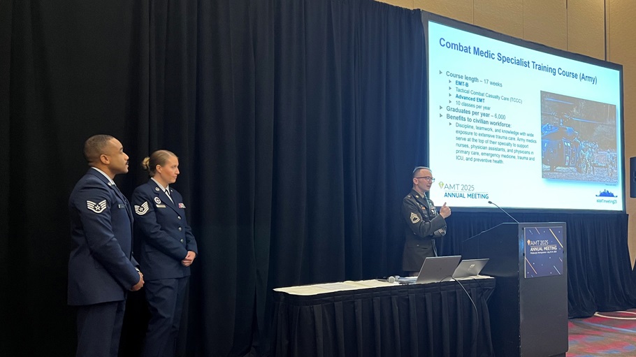 Army Sgt. 1st Class Devin Bigelow, an instructor for the Combat Medic Specialist Training Course (CMSTC) at the Medical Education and Training Campus on Joint Base San Antonio-Fort Sam Houston, Texas, delivers a presentation about the CMSTC at the American Medical Technologists Annual Meeting in Pittsburgh, Pa. July 23 while fellow METC instructors, Air Force Tech. Sgt. Jessica McCleary and Air Force Staff Sgt. Jheryl Stuckey, look on.