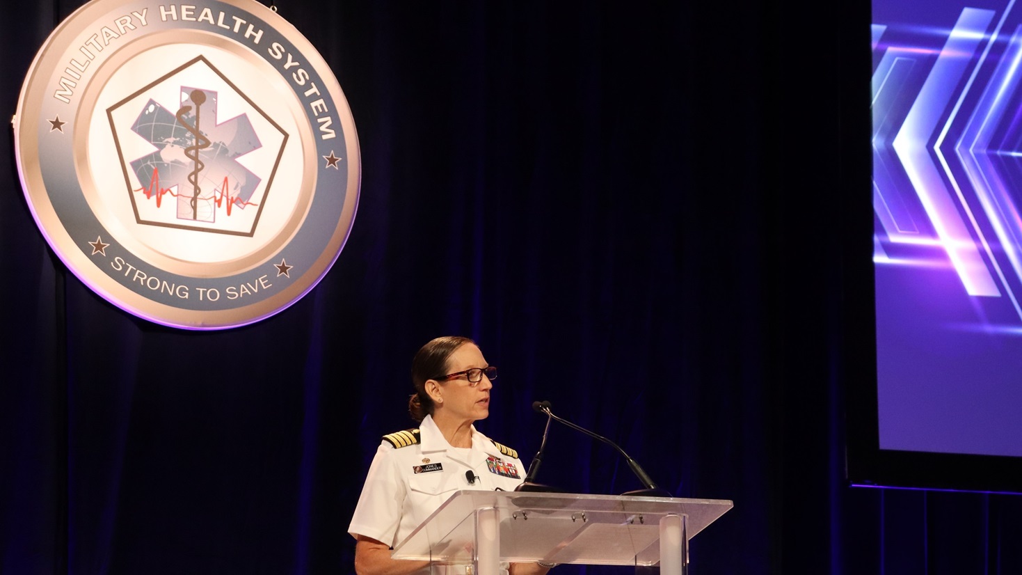 Capt. Franca Jones, commander, Naval Medical Research Command (NMRC), speaks to attendees at the plenary session for the 2025 Military Health Research Symposium. 