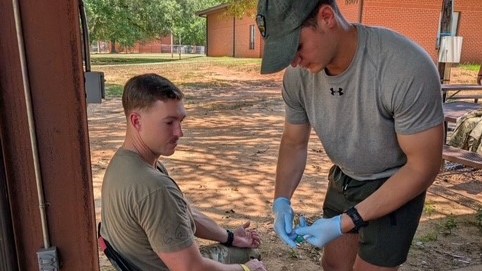 A phlebotomist with the U.S. Army Research Institute of Environmental Medicine prepares to draw blood from a volunteer Soldier prior to physical training at Fort Rucker, Alabama, as part of a study being conducted by USARIEM’s Thermal and Mountain Medicine Division to identify biomarkers associated with heat stress during periods of intense physical exertion.