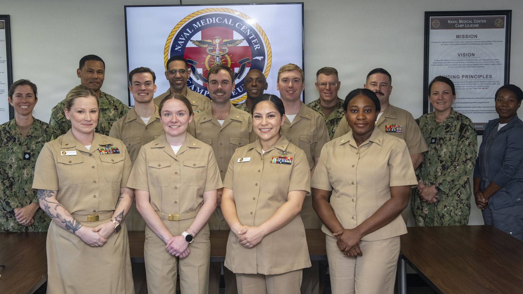 Navy officers assigned to Expeditionary Medical Facility Kilo pose with command leadership and Nursing Residency Program staff after the Training-to-Practice Nurse Residency Program graduation, at Naval Medical Center Camp Lejeune, on November 20, 2025. 
